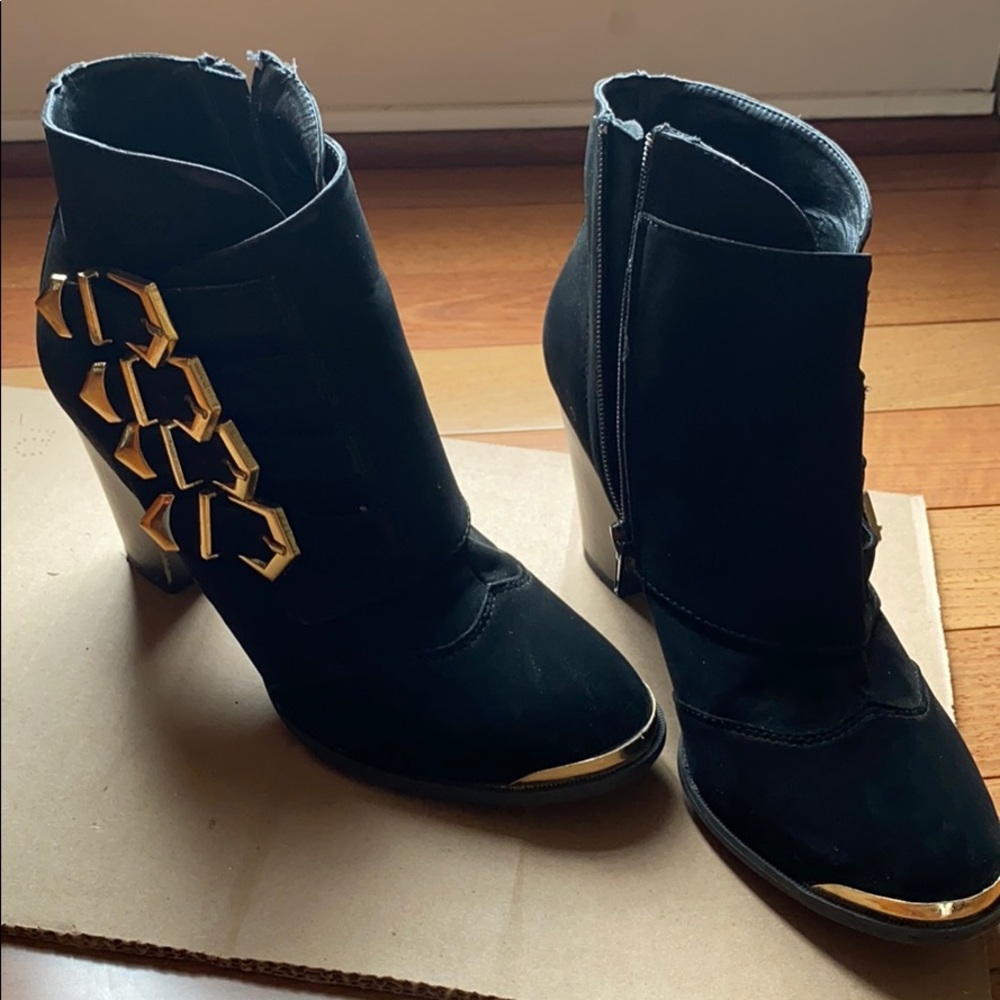 Black booties with gold accents